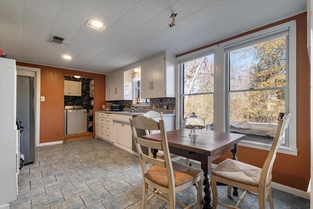 dining room featuring washer / dryer and plenty of natural light