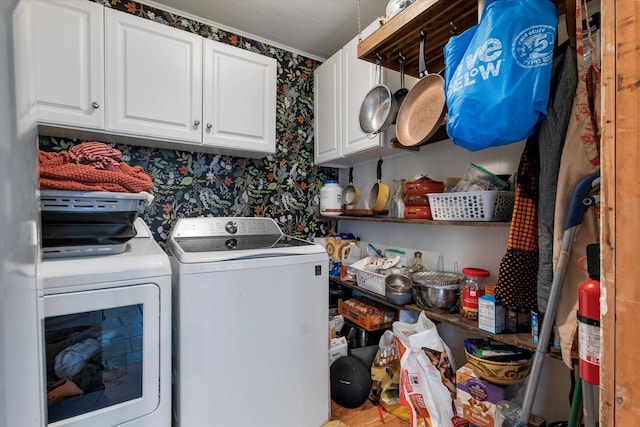 laundry area with washer and dryer and cabinets