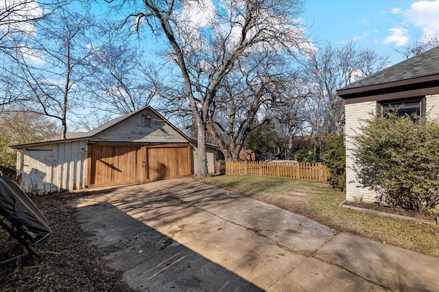 view of property exterior with a garage and an outdoor structure