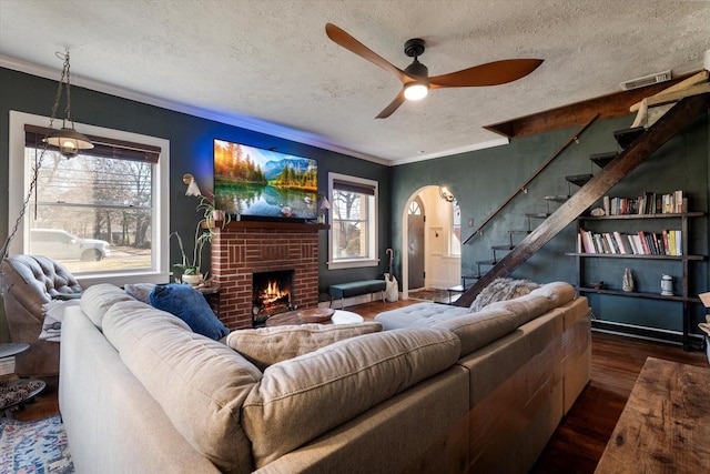 living room with crown molding, dark hardwood / wood-style floors, and a textured ceiling