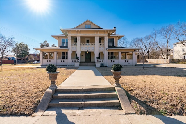 neoclassical home with a porch and a balcony