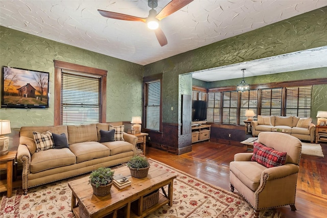 living room with wood-type flooring and ceiling fan