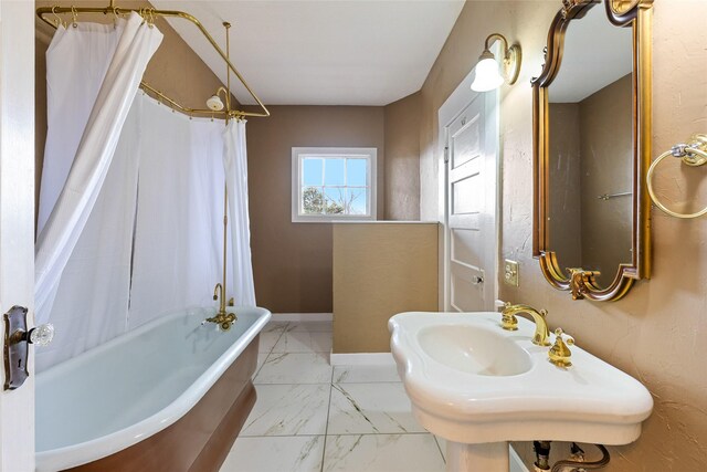 bathroom with sink and shower / bath combo with shower curtain