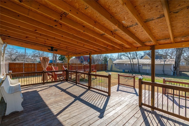 wooden deck featuring a yard and ceiling fan