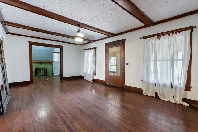 foyer with dark wood-type flooring, beam ceiling, and a textured ceiling