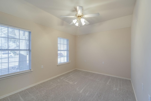 carpeted empty room with plenty of natural light and ceiling fan