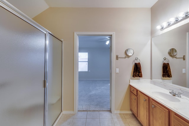 bathroom featuring tile patterned flooring, vanity, lofted ceiling, and a shower with shower door