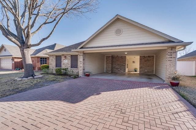 ranch-style house with decorative driveway