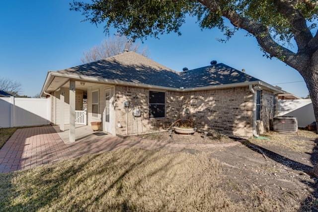 rear view of house with an outdoor fire pit, a yard, and a patio area