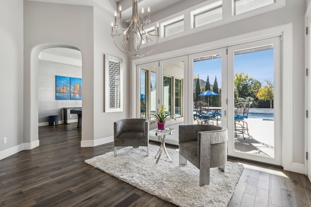 interior space featuring dark wood-type flooring and a chandelier