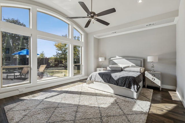 bedroom featuring dark hardwood / wood-style flooring, lofted ceiling, and ceiling fan