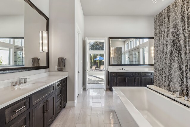 bathroom featuring vanity and a washtub