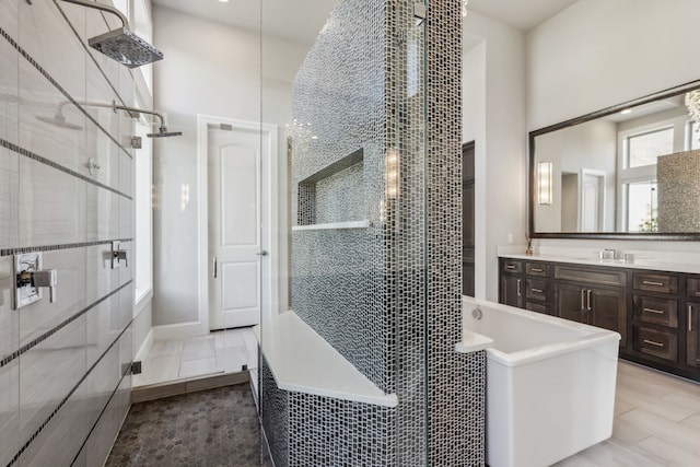 bathroom featuring vanity, a towering ceiling, and separate shower and tub