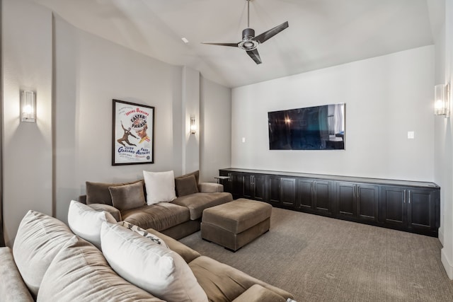 home theater featuring ceiling fan, light colored carpet, and vaulted ceiling