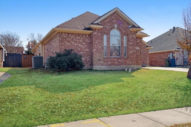 view of front facade with central AC and a front yard