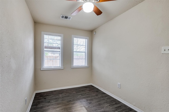 empty room featuring ceiling fan and dark hardwood / wood-style floors