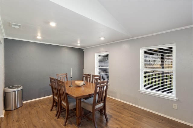 dining room featuring lofted ceiling, dark wood-type flooring, and ornamental molding