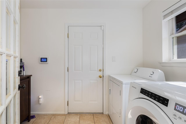 laundry area featuring independent washer and dryer and light tile patterned floors