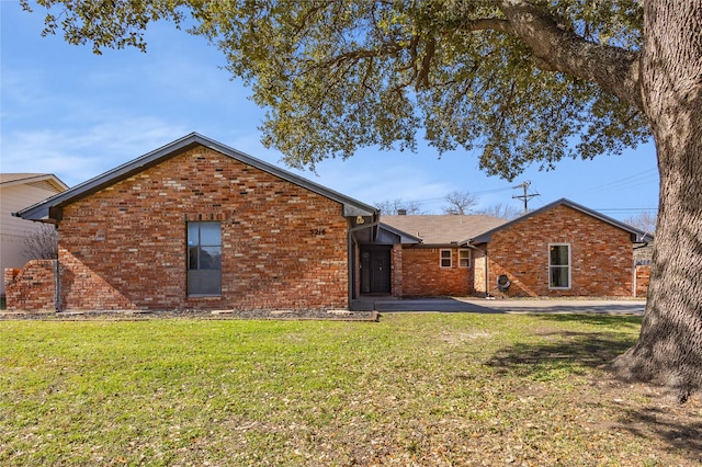 rear view of house featuring a lawn