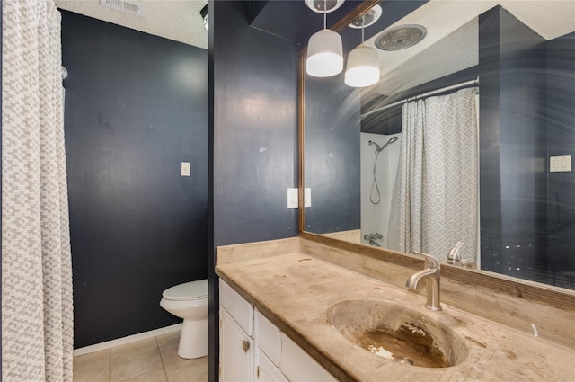 bathroom featuring vanity, tile patterned floors, toilet, and a textured ceiling