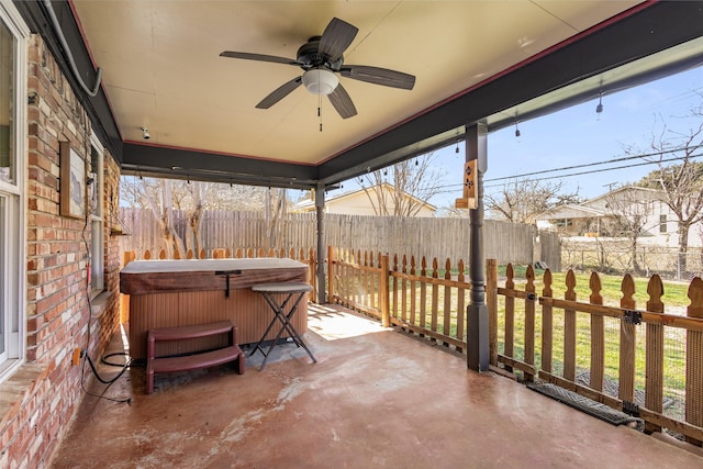 view of patio / terrace with a hot tub and ceiling fan