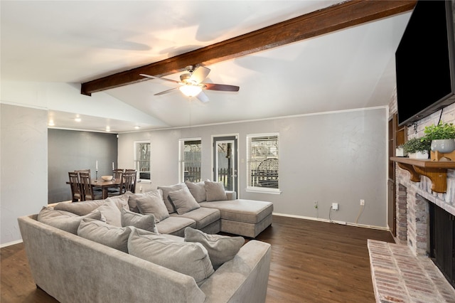 living room featuring ceiling fan, dark hardwood / wood-style floors, a brick fireplace, and vaulted ceiling with beams