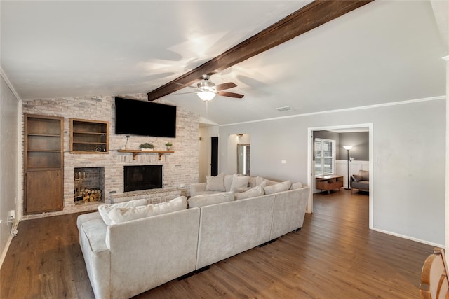 living room with built in shelves, dark hardwood / wood-style floors, a fireplace, and vaulted ceiling with beams