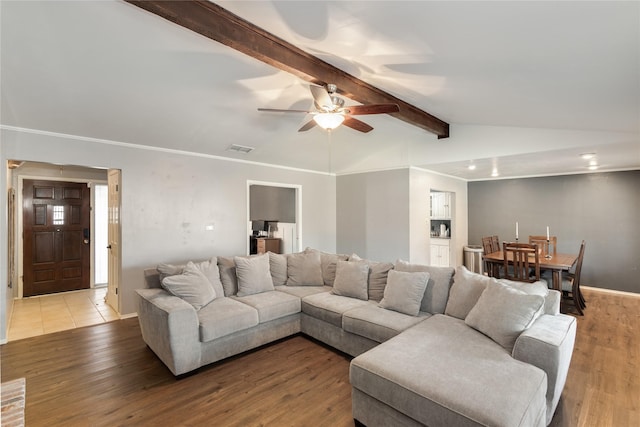 living room featuring vaulted ceiling with beams, ceiling fan, and light hardwood / wood-style flooring