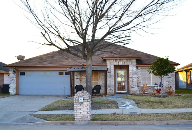 view of front of house with a garage and central air condition unit