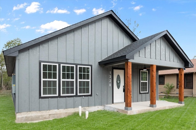 modern inspired farmhouse with a front lawn