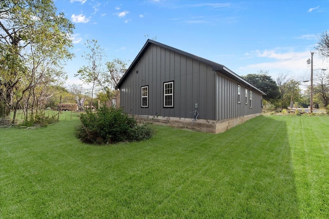 view of side of home with a lawn