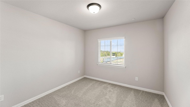 unfurnished room featuring carpet flooring