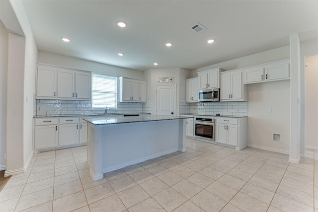 kitchen with white cabinetry and a center island