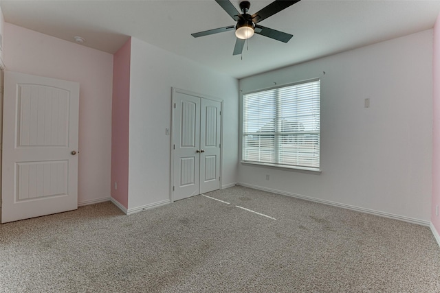 unfurnished bedroom featuring light colored carpet, ceiling fan, and a closet