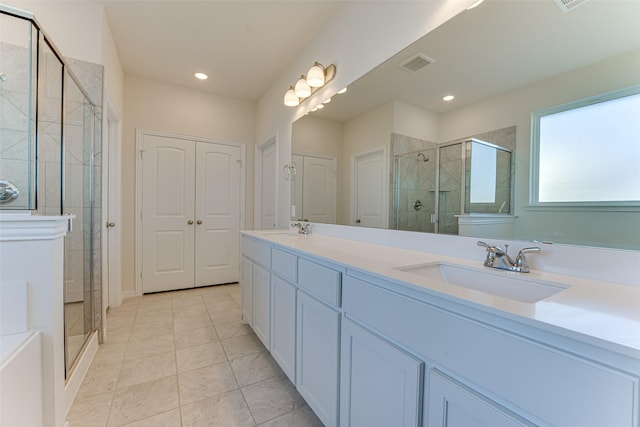 bathroom featuring tile patterned flooring, vanity, and an enclosed shower