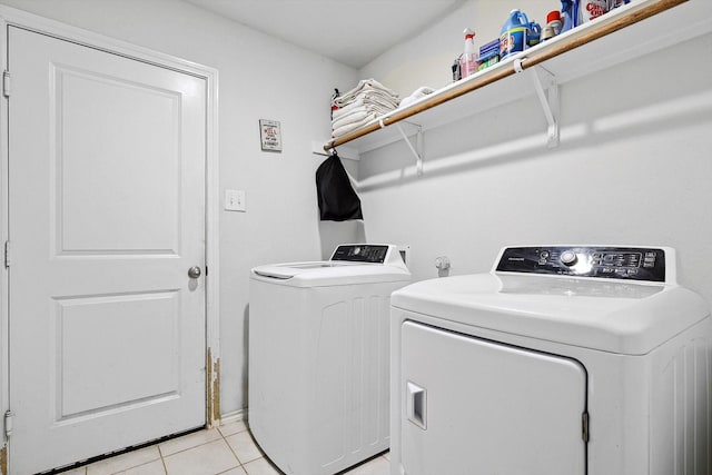 washroom with separate washer and dryer and light tile patterned floors