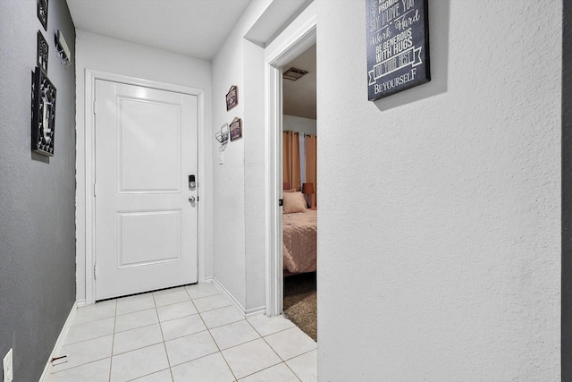 entryway with light tile patterned flooring