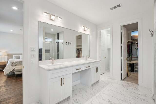 3426 Borger St, Dallas, TX 75212 - ensuite bathroom with a spacious closet, double vanity, a shower stall, recessed lighting, and baseboards