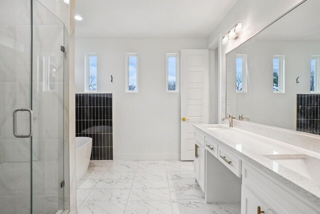 3426 Borger St, Dallas, TX 75212 - bathroom with double vanity, a freestanding tub, a shower stall, marble finish flooring, and baseboards