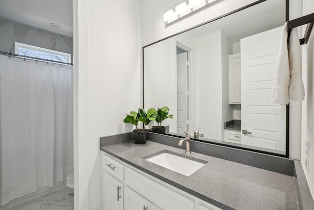 bathroom featuring curtained shower, toilet, marble finish floor, and vanity