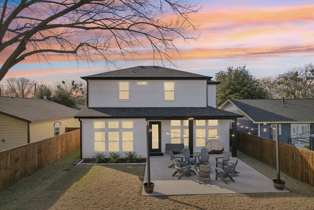 3426 Borger St, Dallas, TX 75212 - back of property at dusk with a patio area and a shingled roof