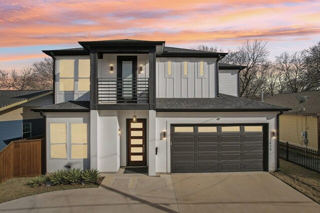 3426 Borger St, Dallas, TX 75212 - view of front of property with a balcony, concrete driveway, a garage, board and batten siding, and roof with shingles