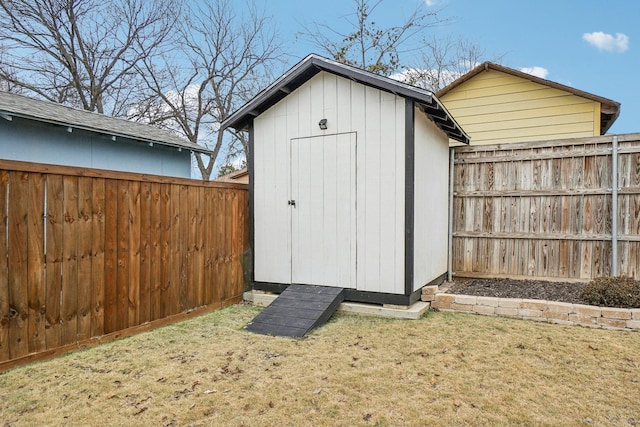 view of shed with a fenced backyard