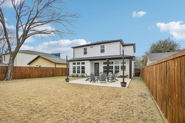 rear view of property featuring a patio, a lawn, central AC unit, and a fenced backyard