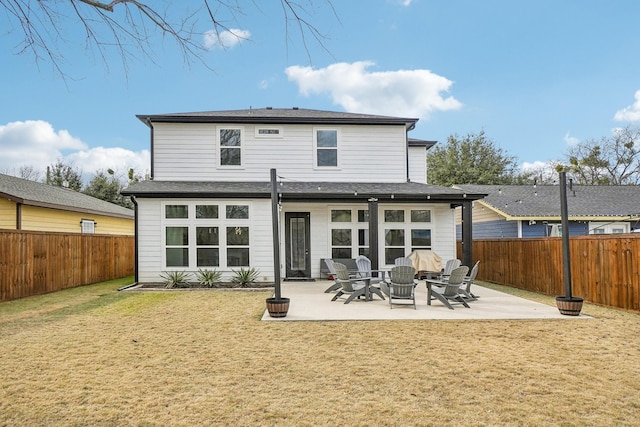 back of property with a patio, a lawn, and a fenced backyard