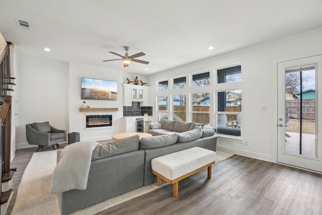 living room featuring dark wood-type flooring, beverage cooler, and ceiling fan