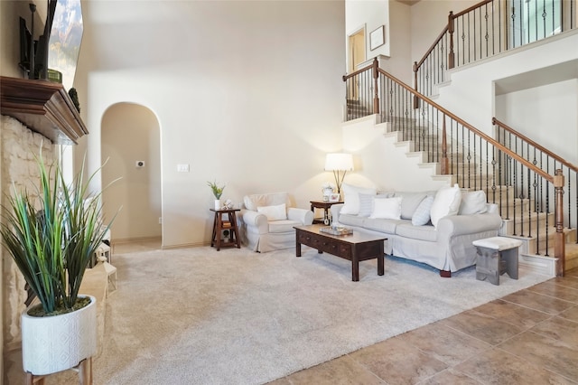 living room featuring light tile patterned floors and a towering ceiling