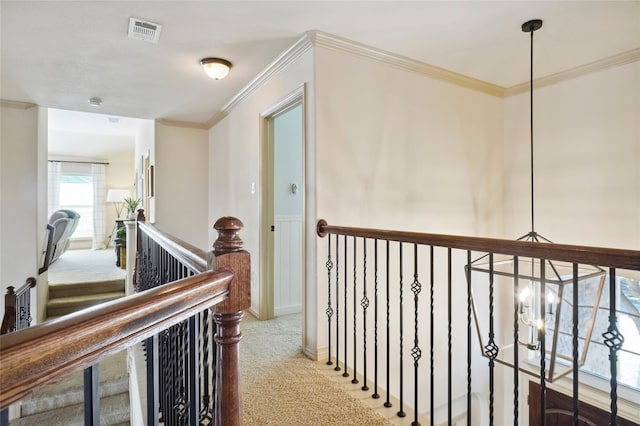 corridor with crown molding and carpet flooring