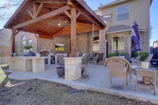 view of patio with an outdoor kitchen and a grill