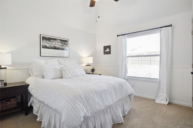 bedroom with ceiling fan, light carpet, and multiple windows